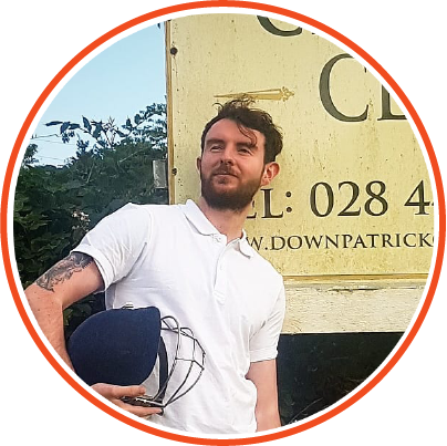 man standing proudly with cricket helmet