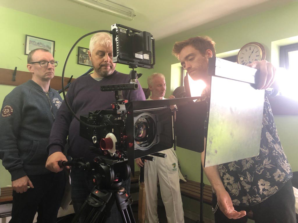 camera crew in cricket club changing room